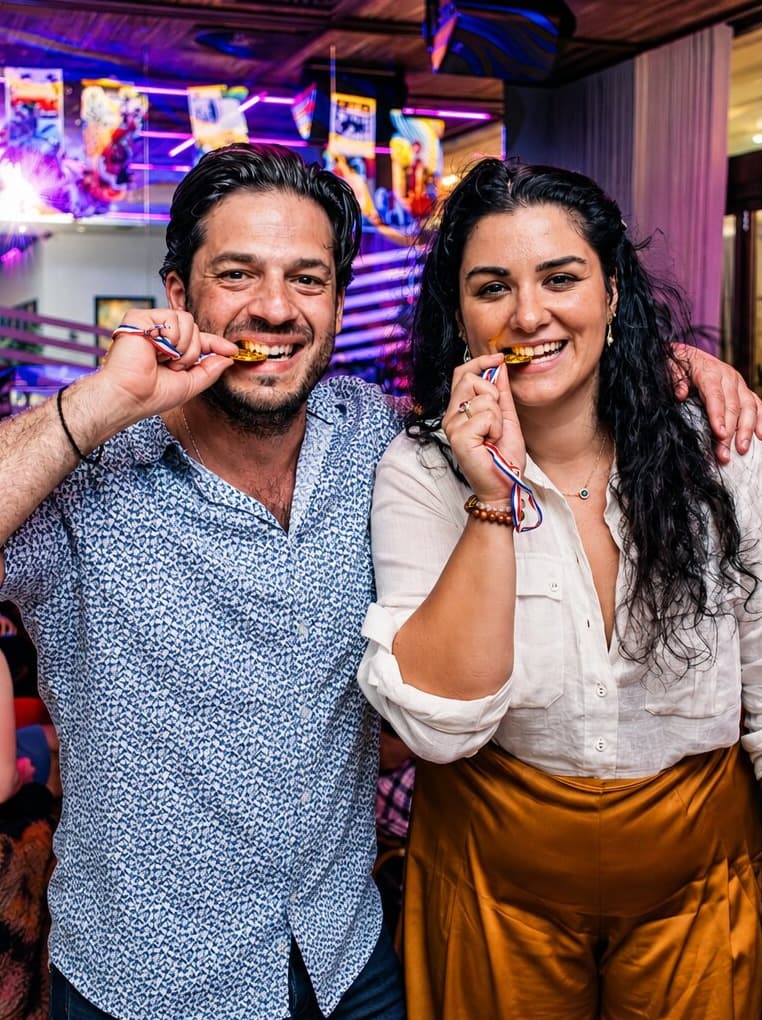 Two agents biting their medals in celebration